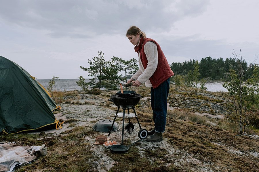 Woman camping with a BBQ