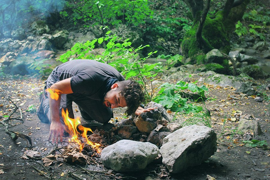 Solo camper starting a fire