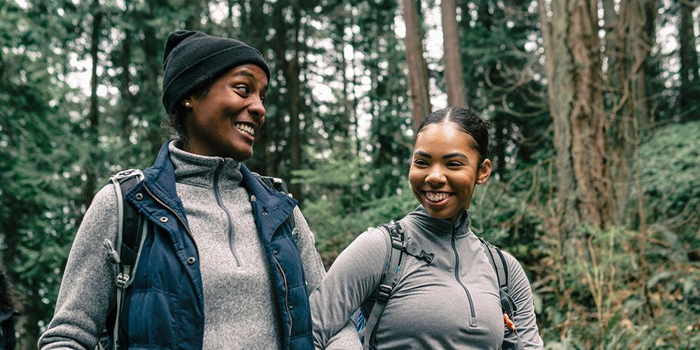 Women laughing while hiking