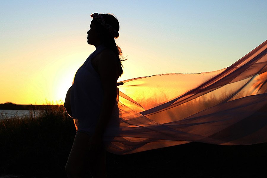 pregnant woman at sunset